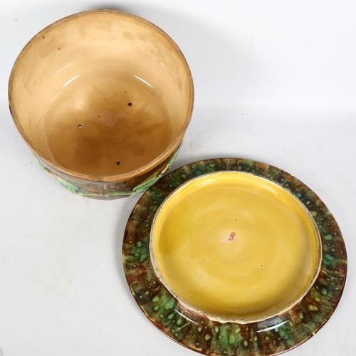 303 - A Majolica cheese dome and cover, with floral relief decoration, board diameter 28cm, overall height... 