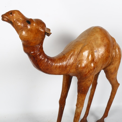 322 - A leather wrapped sculpture of a camel, H34cm, L47cm