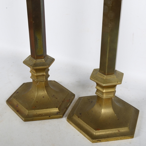 324 - A pair of Rostand brass Gothic style candlesticks, H64cm, there is an applied stamp on the base and ... 