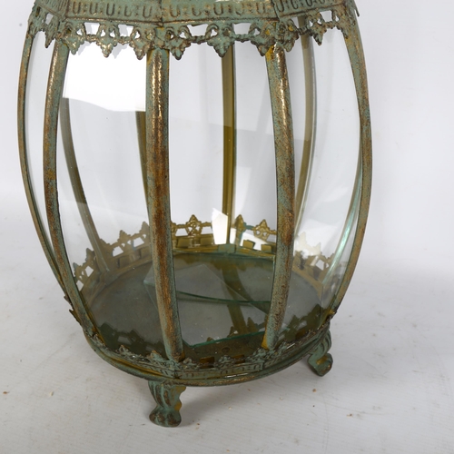 326 - An Islamic pattern bulbous lantern on 4 feet, with fitted glass panels, H48cm