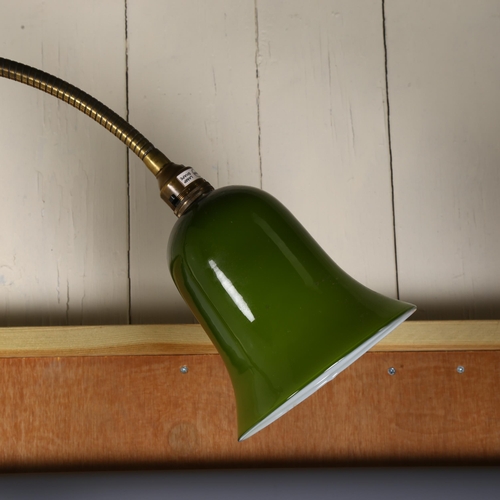 332 - A brass floor standing desk light with green glass lamp shade, height with shade bent over 115cm