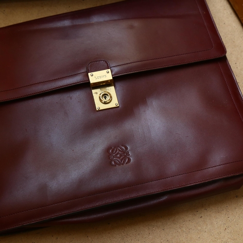 349 - A Loewe leather briefcase, with brass mounts and carrying strap, 37.5cm across, and a leather Gladst... 