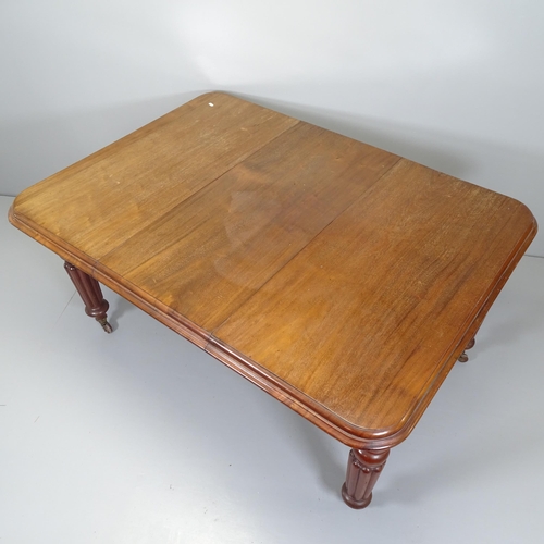 2664 - A 19th century mahogany wind-out dining table, with single spare leaf and raised on turned and flute... 