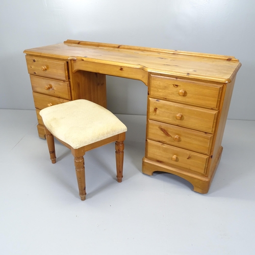 2666 - A modern pine kneehole dressing table / desk with nine fitted drawers. 146x76x45cm, and a matching s... 