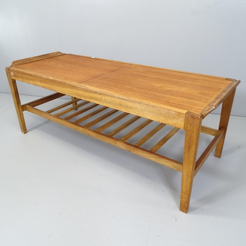 2668 - A mid-century teak two-tier extending coffee table, with label for Remploy. 113x41x45cm.