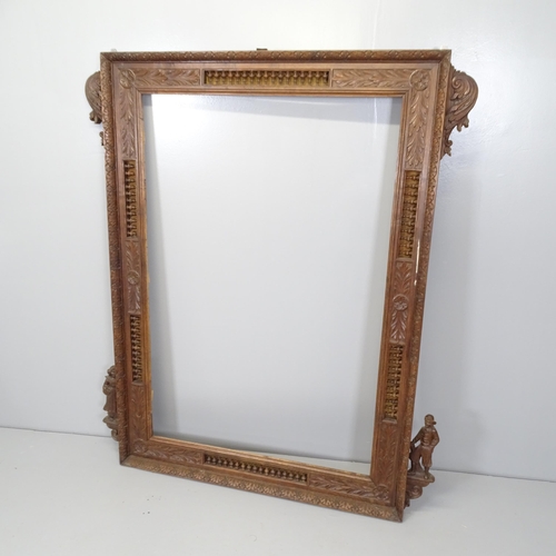 2694 - An antique oak Arts and Crafts picture/mirror frame, with all over carved and pierced decoration. 12... 