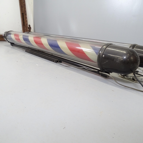 2700 - A pair of wall mounted barber's poles. Height 190cm.