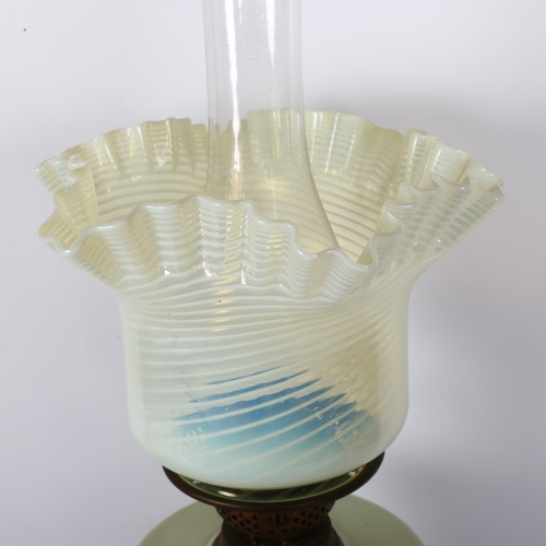 10 - A Victorian oil lamp, having a frilled vaseline glass shade with painted glass font, on a turned pai... 