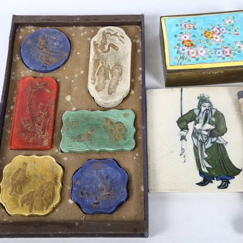 124 - A tray of coloured Chinese ink blocks, a brass box with enamelled lid, a Tibetan painting, tile etc