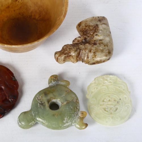 126 - A group of Oriental jade and soapstone pendants, small tea bowl etc (5)