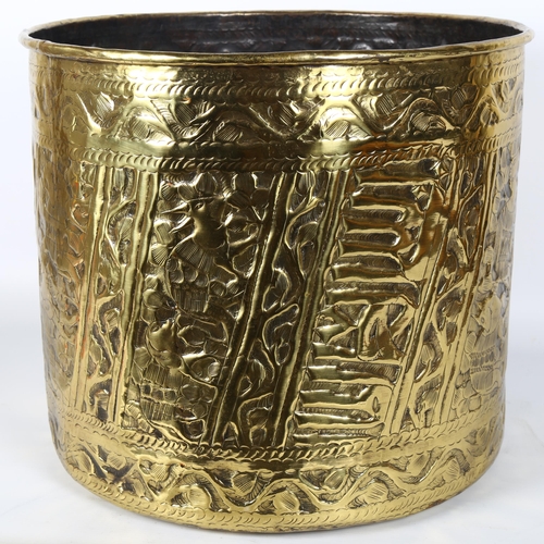 14 - A large Middle Eastern brass planter/jardiniere, allover engraved and embossed animal decoration, di... 