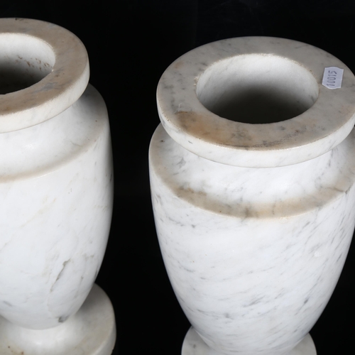 192 - A pair of white and grey veined turned marble urns on foot, H30cm