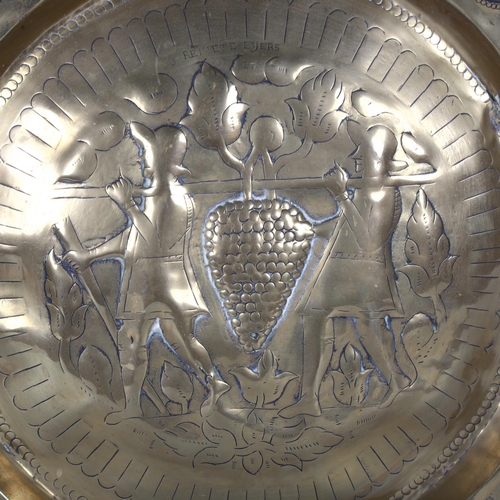 21 - A large 17th century brass alms dish, the central boss depicting the two thieves from the Land of Ca... 