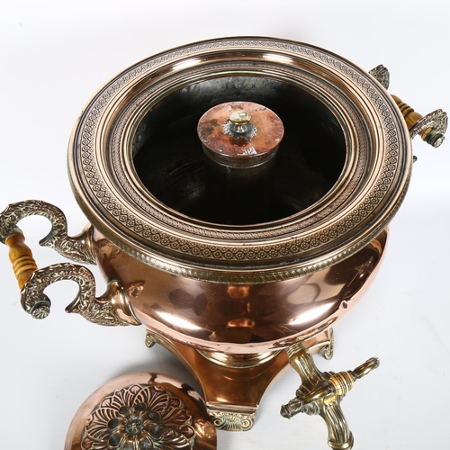 25 - A large highly polished brass and copper 2-handled samovar, on a shaped quatrefoil base and scrolled... 