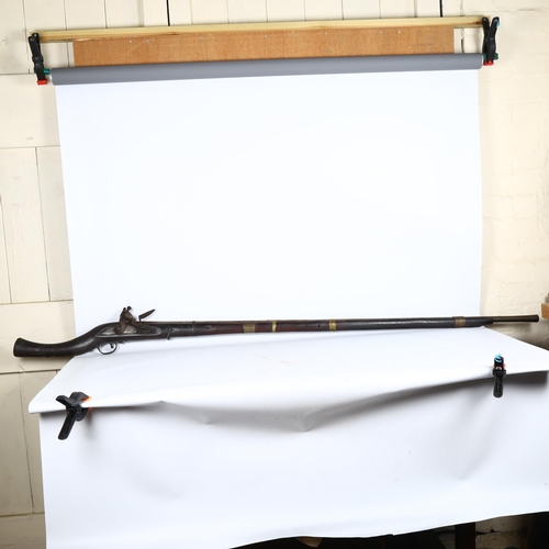 57 - An 18th/19th century Indian Taradar flintlock rifle, length 173cm