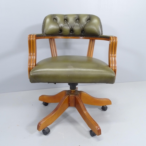 2195 - A reproduction mahogany and leather upholstered swivel desk chair.