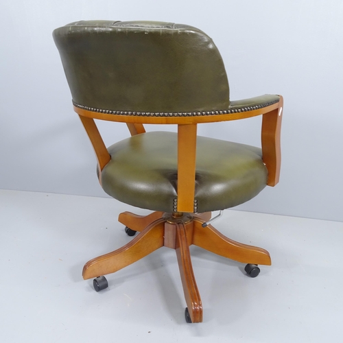 2195 - A reproduction mahogany and leather upholstered swivel desk chair.