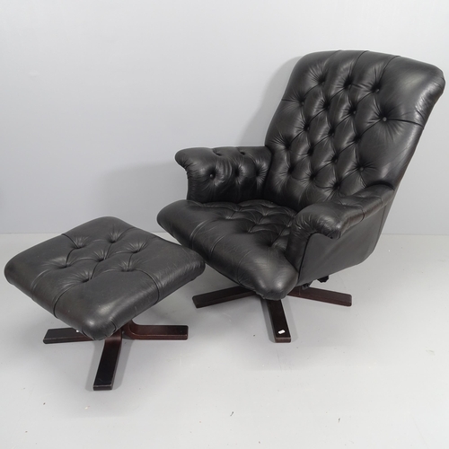 2197 - A mid-century black button-back leather upholstered swivel lounge chair, with matching foot stool.