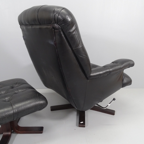 2197 - A mid-century black button-back leather upholstered swivel lounge chair, with matching foot stool.