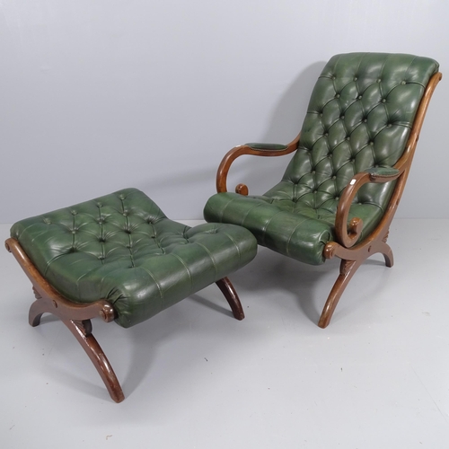 2200 - A green studded leather upholstered armchair, on x-frame legs, with matching ottoman.