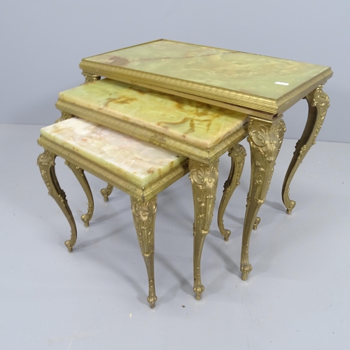 2204 - A continental style nest of three brass and onyx occasional tables. largest 56x46x35cm.