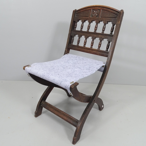 2205 - Bruce J. Talbert, a late Victorian Aesthetic folding oak chair in oak with ornate back.