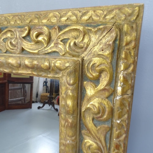 2255 - An antique continental gilt painted wall mirror, with applied carved decoration. 96x103x6cm.