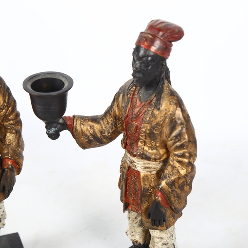 446 - A pair of painted and gilded bronze figural candlesticks on plinths, H22cm