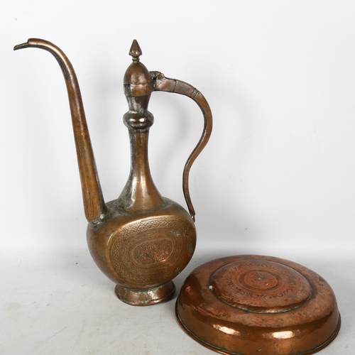 450 - A copper Turkish design coffee pot, and an engraved copper bowl