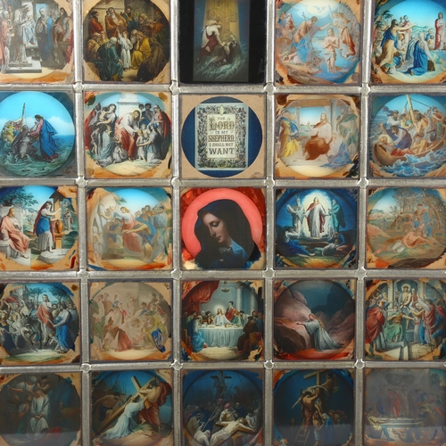 471 - A late 20th century lightbox, the leadlight glass panel depicting 45 religious scenes, the central o... 