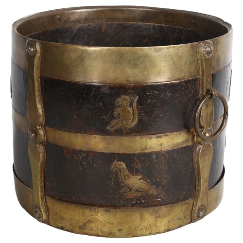 490 - A 19th century Indian wood and brass-bound bucket with ring handles, stylised strapwork and animal d... 