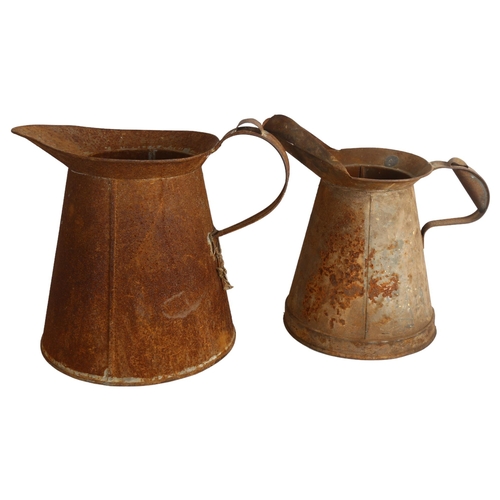 493 - 2 steel jugs, tallest 32cm