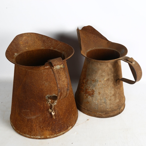 493 - 2 steel jugs, tallest 32cm