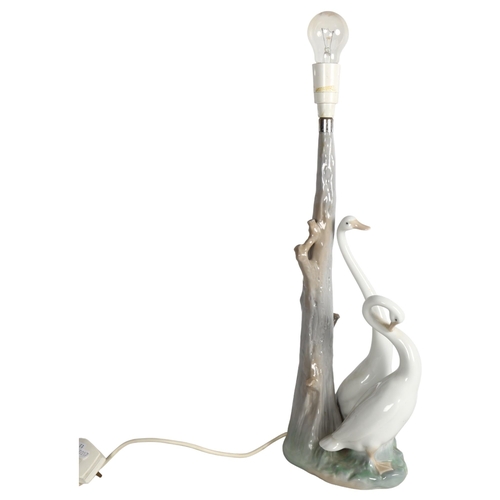 496 - A NAO porcelain table lamp supported by 2 ducks, GWO, height overall 62cm