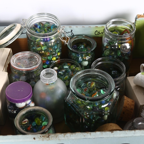 506 - A box containing a large number of jars of glass marbles