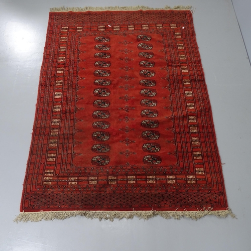 2288 - A red-ground Afghan rug, with gul lozenge. 180x126cm.