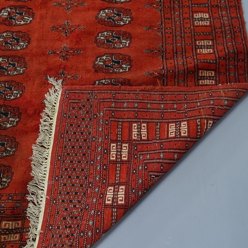 2288 - A red-ground Afghan rug, with gul lozenge. 180x126cm.