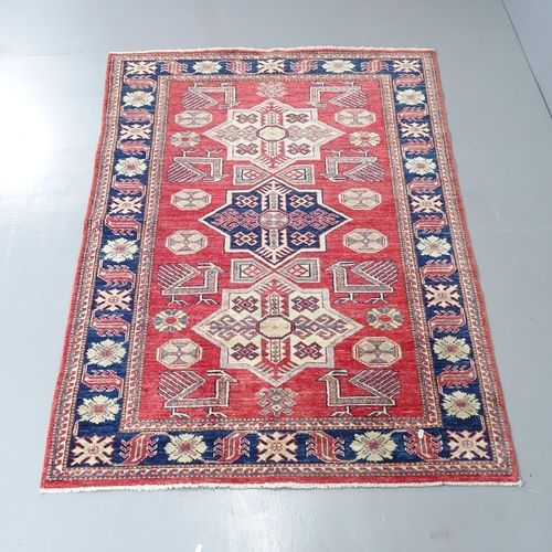 2290 - A red-ground Kazak rug. 172x121cm.