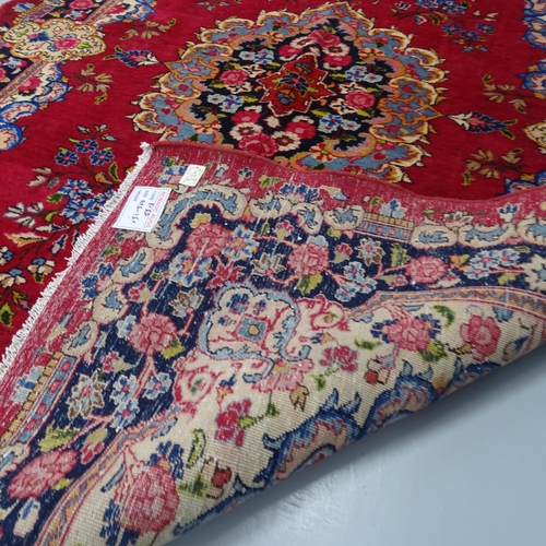 2311 - A red-ground Kirman carpet. 226x149cm