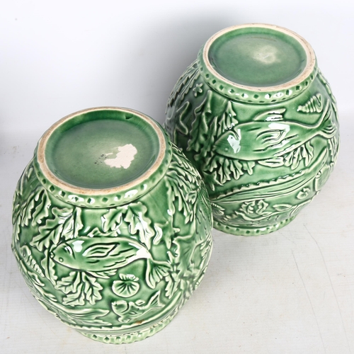 682 - A pair of French green glaze pottery vases, with relief moulded under-sea decoration, height 21cm