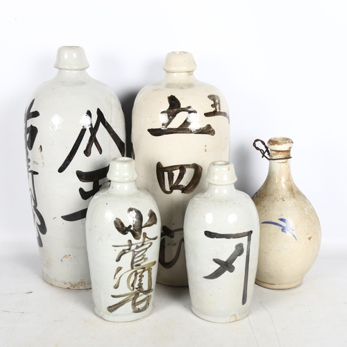 687 - A group of 5 Tokkuri ceramic Sake bottles, largest height 37cm