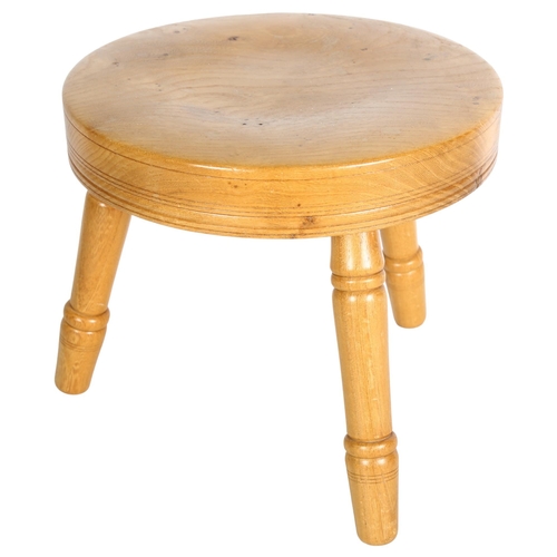 711 - An oak and elm 3-legged stool, H24cm