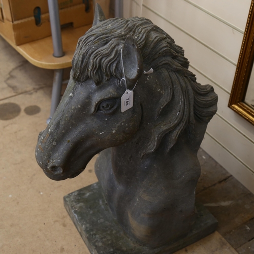 744 - A heavy carved granite horse's head with attached plinth. H - 66cm.