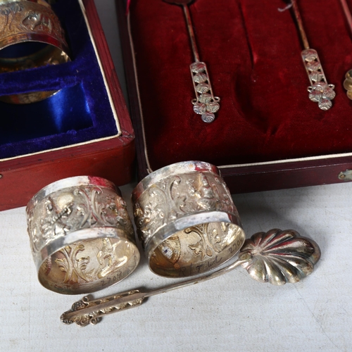 808 - A set of Indian white metal napkin rings, with relief elephant decoration, and a cased set of 6 whit... 