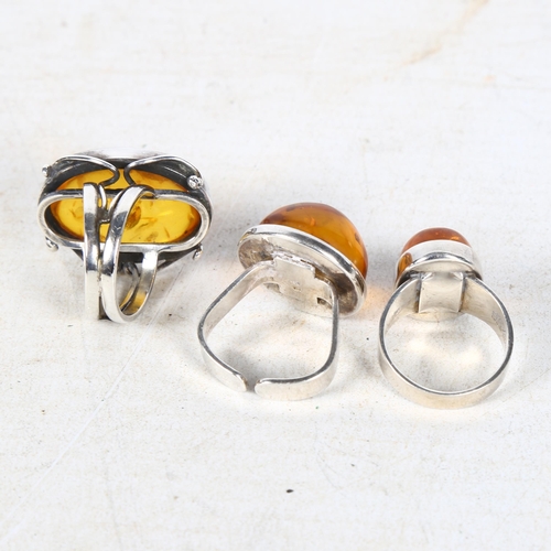 846 - N E FROM - a Danish sterling silver and amber set ring, and 2 other silver and amber rings by a diff... 