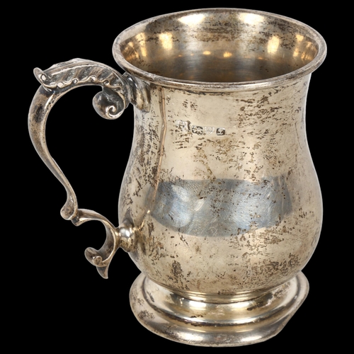 889 - A George V silver christening mug, with leaf design handle, hallmarks for Chester 1911, 4.2oz