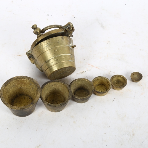 578 - A set of 6 cast-brass resting weights, in cast-brass bucket container