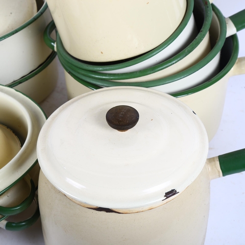 589 - A collection of Vintage cream and green enamelled cookware, including 7 various saucepans, 3 cassero... 