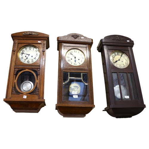 595 - An oak-cased 8-day wall clock, height 74cm, and 2 similar wall clocks