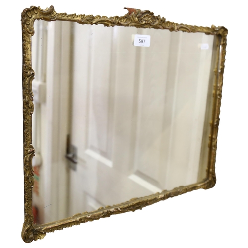 597 - A wall mirror in Antique gilt scrolled frame, 39cm x 47cm